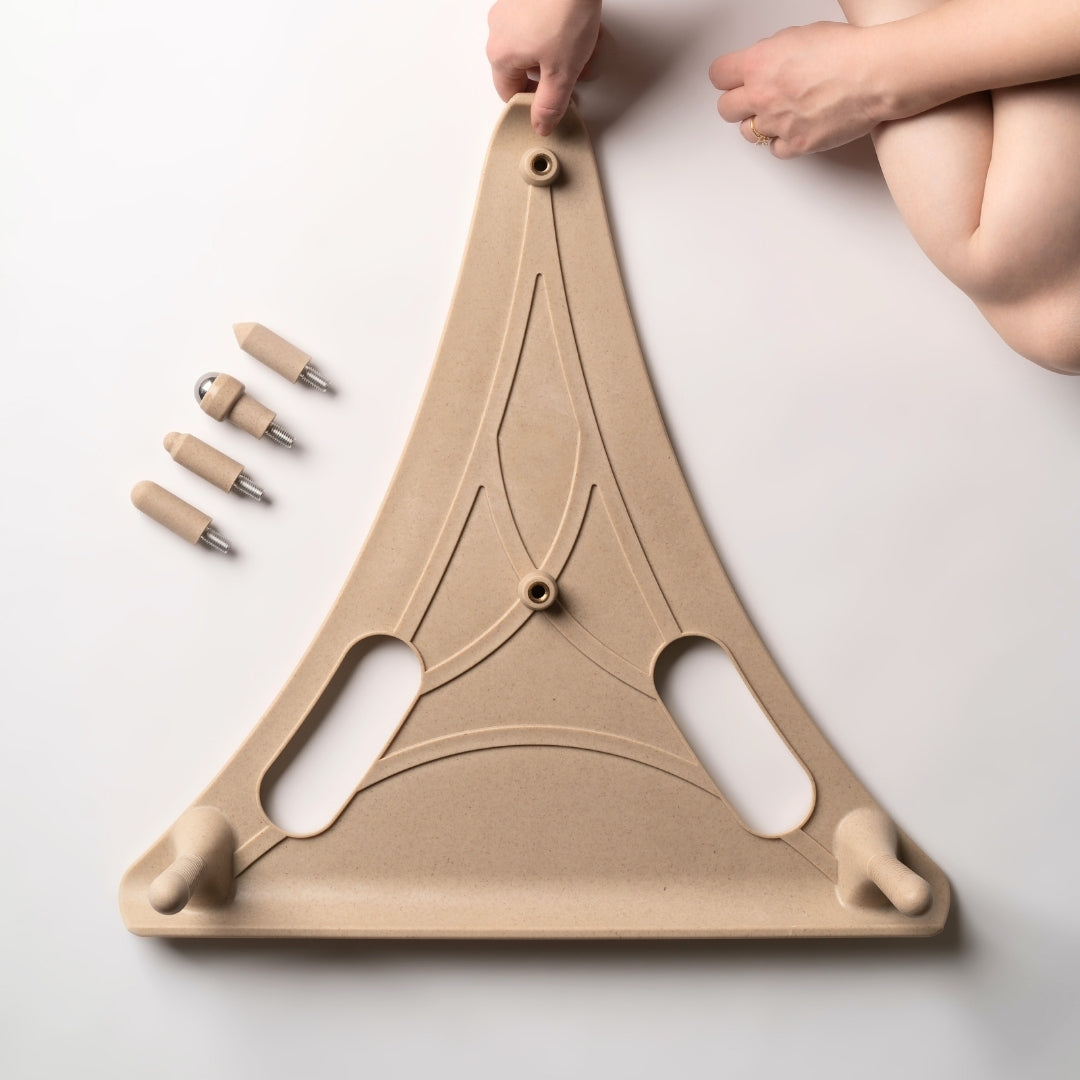 Hands examining the Reliefboard with pegs arranged beside it